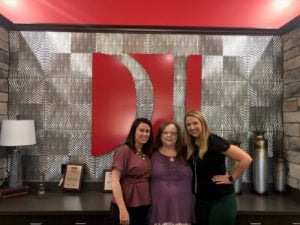 Attorneys Melissa Pope and Jessica Brunken with client P.H.